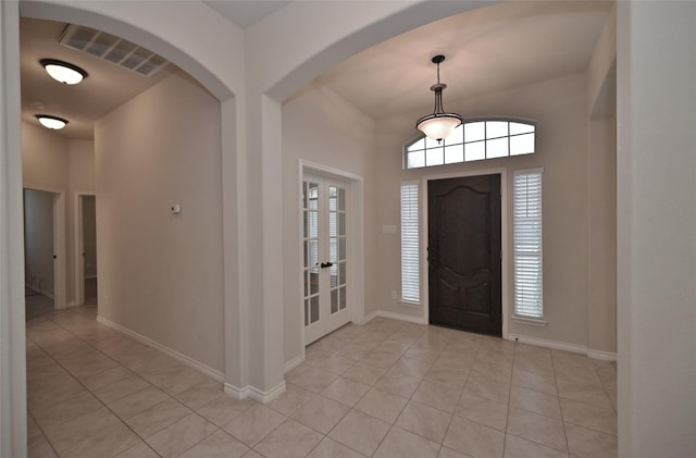 entryway with light tile patterned flooring