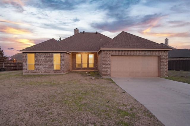 view of front of property featuring a garage and a yard