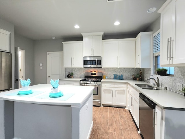 kitchen featuring sink, white cabinets, and appliances with stainless steel finishes