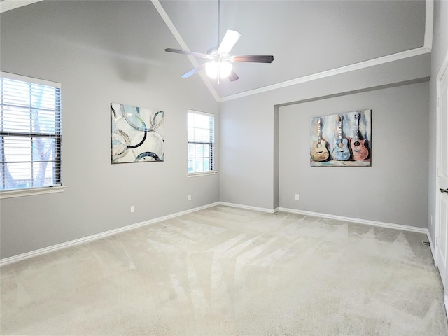 spare room featuring light carpet, ornamental molding, and lofted ceiling