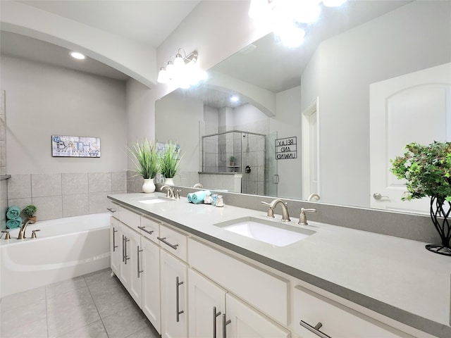 bathroom featuring independent shower and bath, tile patterned flooring, and vanity