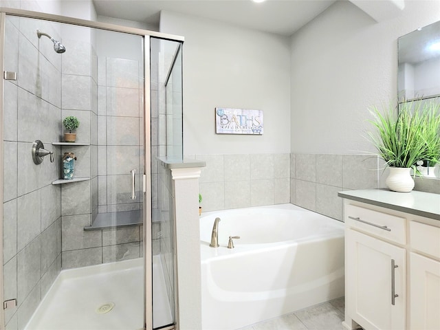 bathroom featuring vanity, tile patterned floors, and separate shower and tub