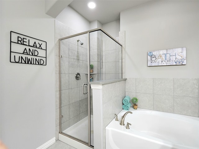 bathroom featuring independent shower and bath and tile patterned flooring