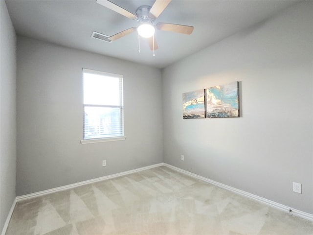 carpeted empty room featuring ceiling fan