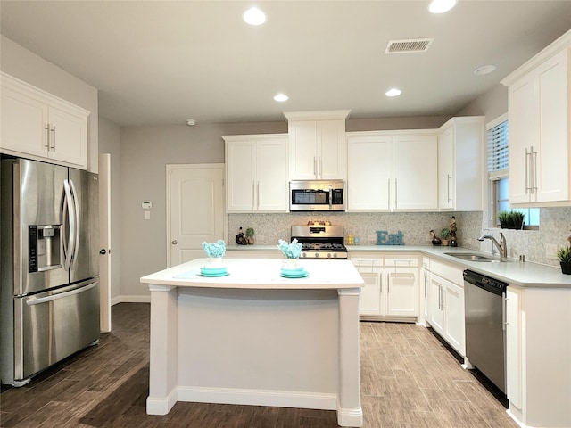 kitchen with white cabinets, stainless steel appliances, and a center island