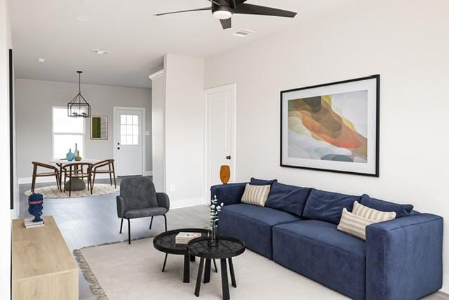 living room featuring hardwood / wood-style flooring and ceiling fan