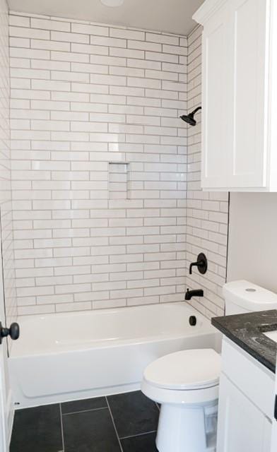 full bathroom with tile patterned flooring, vanity, toilet, and tiled shower / bath