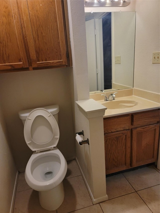 bathroom with tile patterned floors, toilet, and vanity