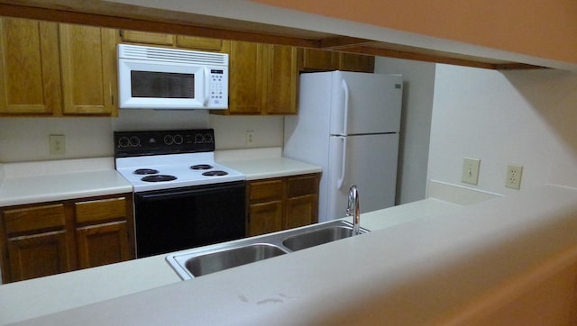 kitchen with white appliances and sink