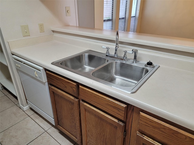 kitchen with light tile patterned flooring, dishwasher, and sink