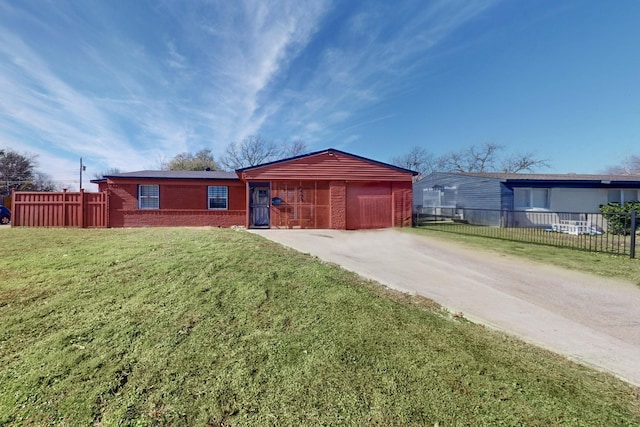 ranch-style house featuring a garage and a front lawn