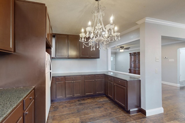 kitchen with crown molding, dark hardwood / wood-style flooring, decorative light fixtures, and ceiling fan with notable chandelier