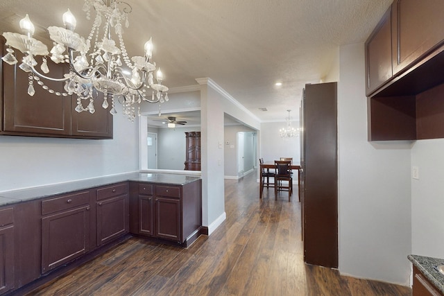 kitchen featuring ornamental molding, dark hardwood / wood-style flooring, kitchen peninsula, and ceiling fan with notable chandelier