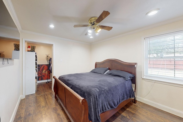 bedroom featuring dark wood-type flooring, ceiling fan, ornamental molding, and a closet