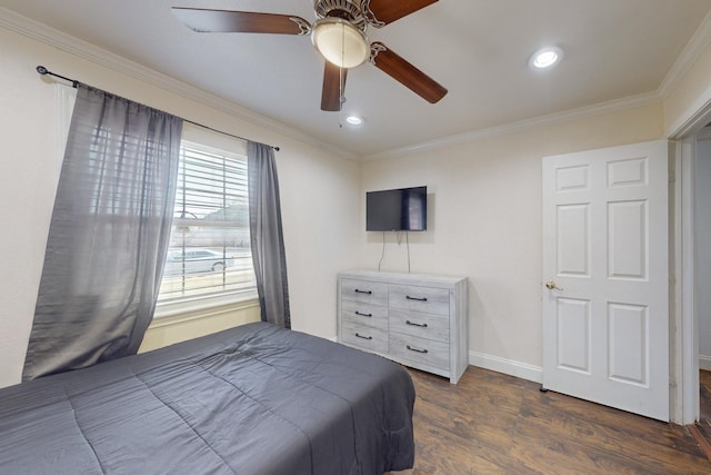 bedroom with ornamental molding, dark wood-type flooring, and ceiling fan