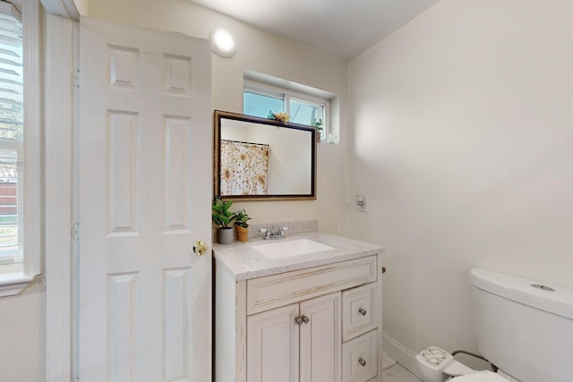 bathroom featuring vanity and toilet