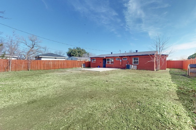 view of yard with central AC and a patio area