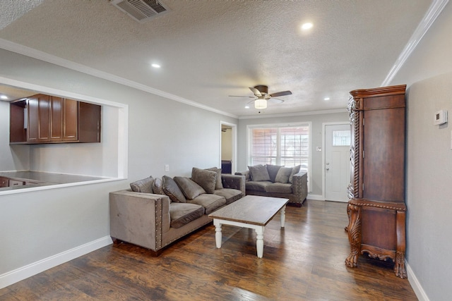 living room with crown molding, dark hardwood / wood-style floors, ceiling fan, and a textured ceiling