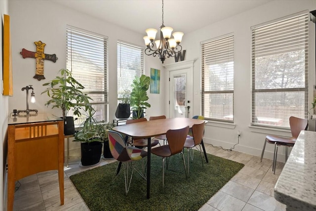 tiled dining area featuring an inviting chandelier