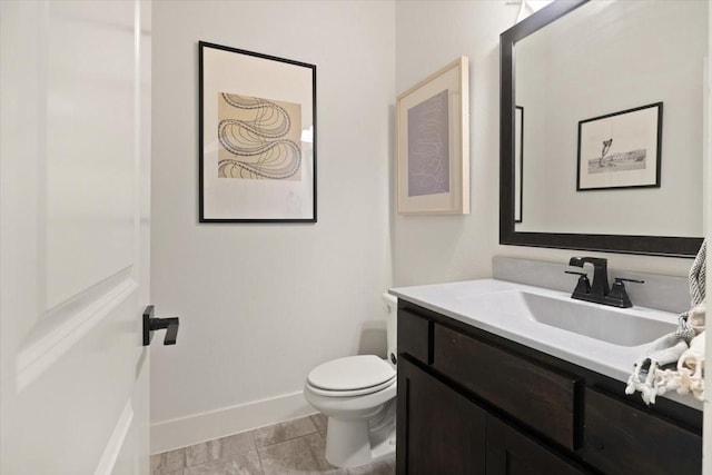 bathroom with tile patterned flooring, vanity, and toilet