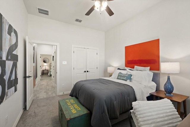 carpeted bedroom with ceiling fan and a closet