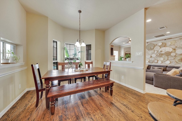 dining room featuring a notable chandelier, hardwood / wood-style flooring, and ornamental molding