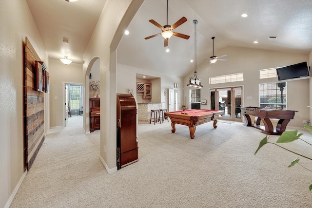 game room featuring light carpet, a towering ceiling, pool table, and indoor bar