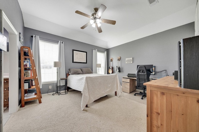 bedroom featuring vaulted ceiling, ceiling fan, light colored carpet, and multiple windows