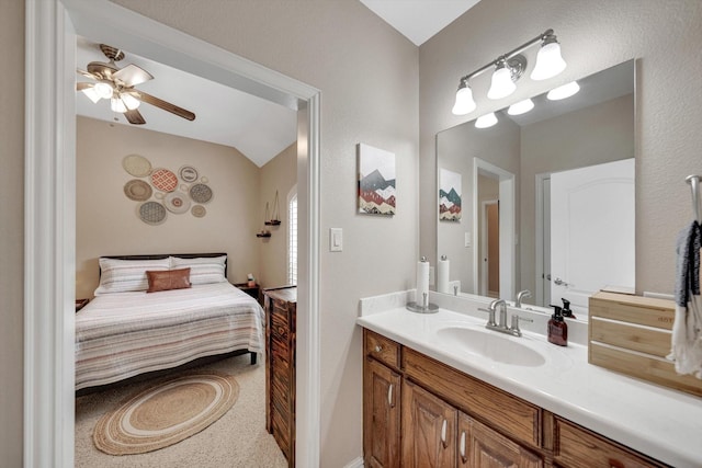 bathroom featuring ceiling fan, lofted ceiling, and vanity