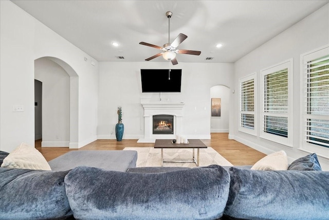 living room with ceiling fan and light hardwood / wood-style floors