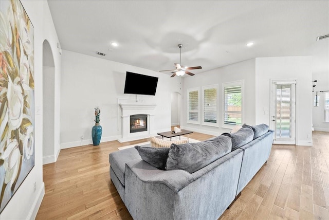 living room featuring ceiling fan and light wood-type flooring