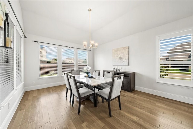 dining room featuring an inviting chandelier and hardwood / wood-style flooring