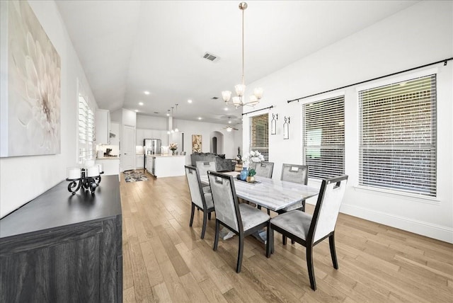 dining room with an inviting chandelier and light hardwood / wood-style floors