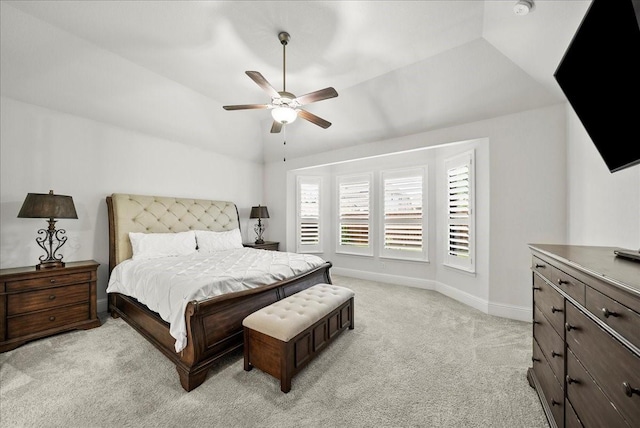 carpeted bedroom with ceiling fan and vaulted ceiling