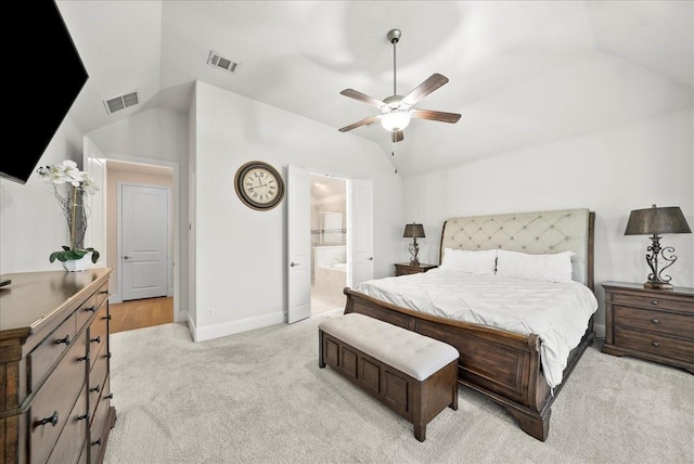 carpeted bedroom featuring lofted ceiling, ceiling fan, and ensuite bath