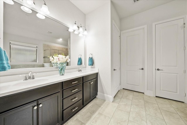 bathroom with vanity, tile patterned flooring, and a shower with door