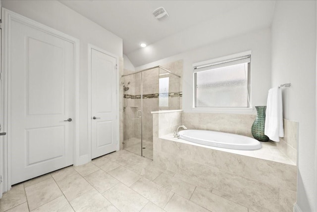 bathroom featuring tile patterned floors and separate shower and tub