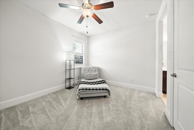 sitting room featuring light colored carpet and ceiling fan