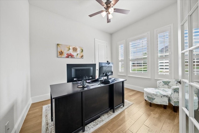 office space with ceiling fan, light hardwood / wood-style floors, and french doors