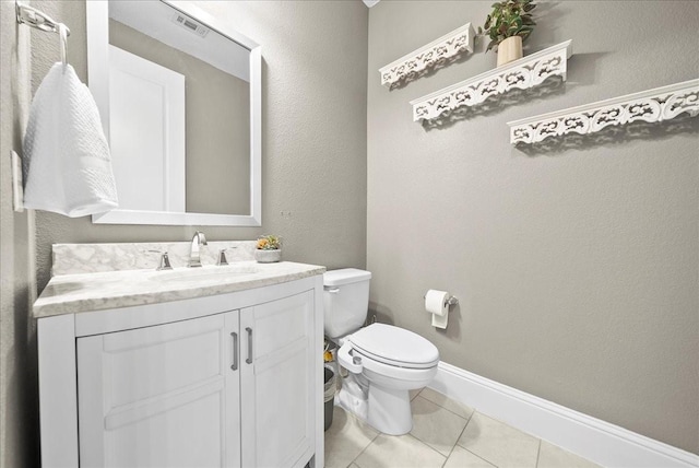 bathroom with tile patterned flooring, vanity, and toilet