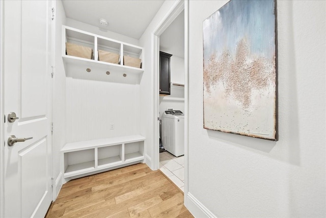 mudroom featuring hardwood / wood-style flooring and washer / dryer