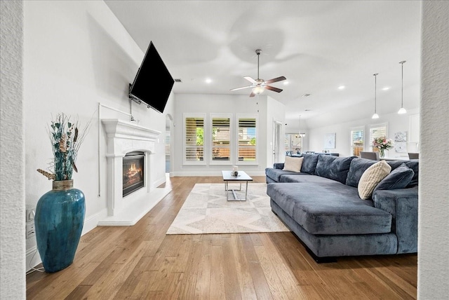 living room featuring hardwood / wood-style flooring and ceiling fan