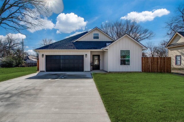 view of front of house with a garage and a front yard