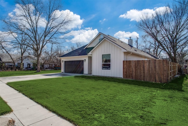 view of side of home with a garage and a yard