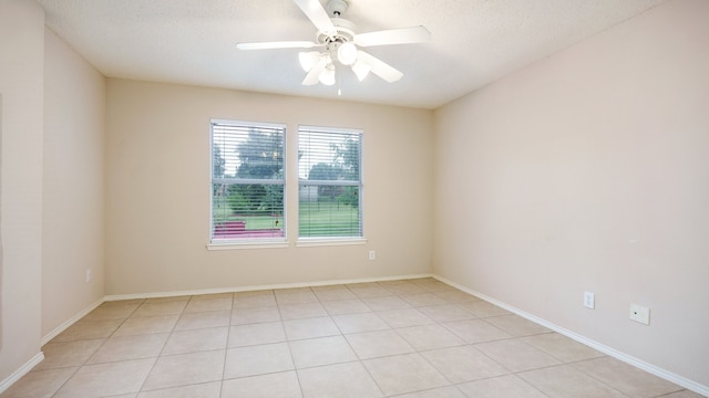 unfurnished room featuring light tile patterned floors, a textured ceiling, and ceiling fan