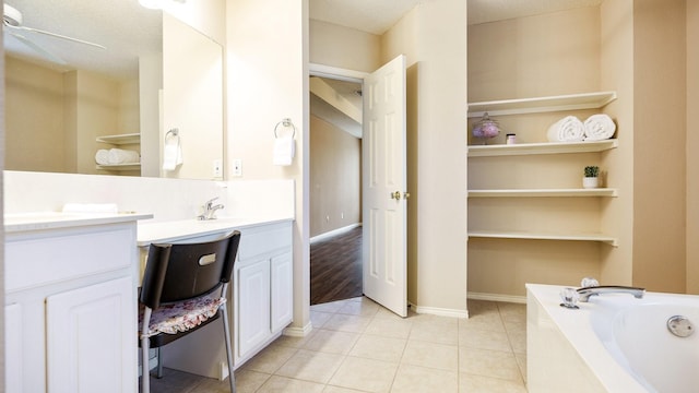 full bath with a garden tub, a ceiling fan, baseboards, tile patterned flooring, and vanity