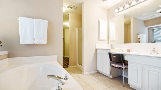 full bathroom with a sink, tile patterned flooring, a shower stall, a ceiling fan, and a garden tub