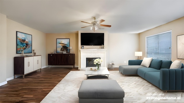 living room with baseboards, wood finished floors, a ceiling fan, and a fireplace