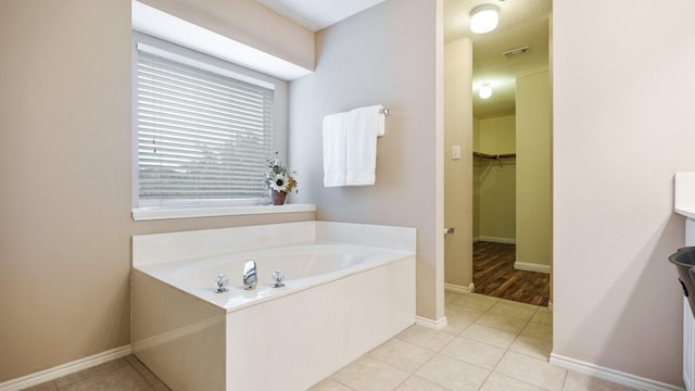 bathroom with tile patterned flooring and a bathtub