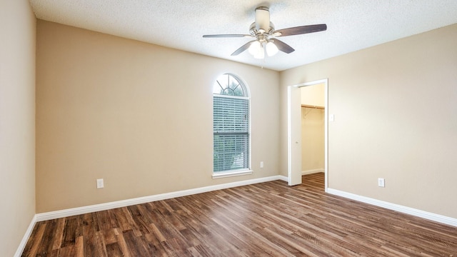 empty room with wood-type flooring, a textured ceiling, and ceiling fan